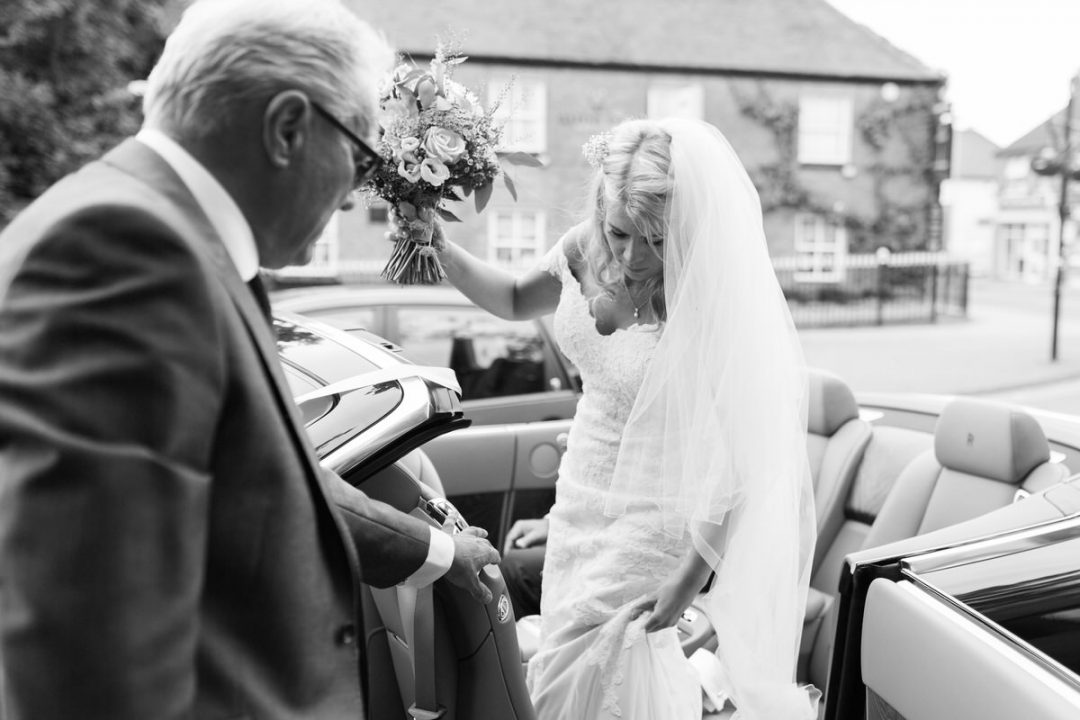 bride getting out of wedding car