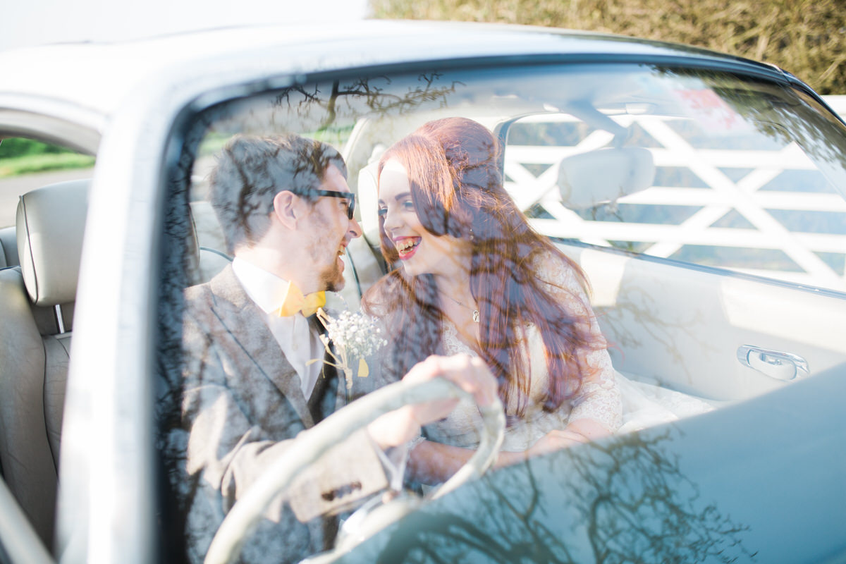 Wedding couple in car at The Compasses at Pattiswick wedding venue. Photographed by recommended wedding photographer, Gemma Giorgio.