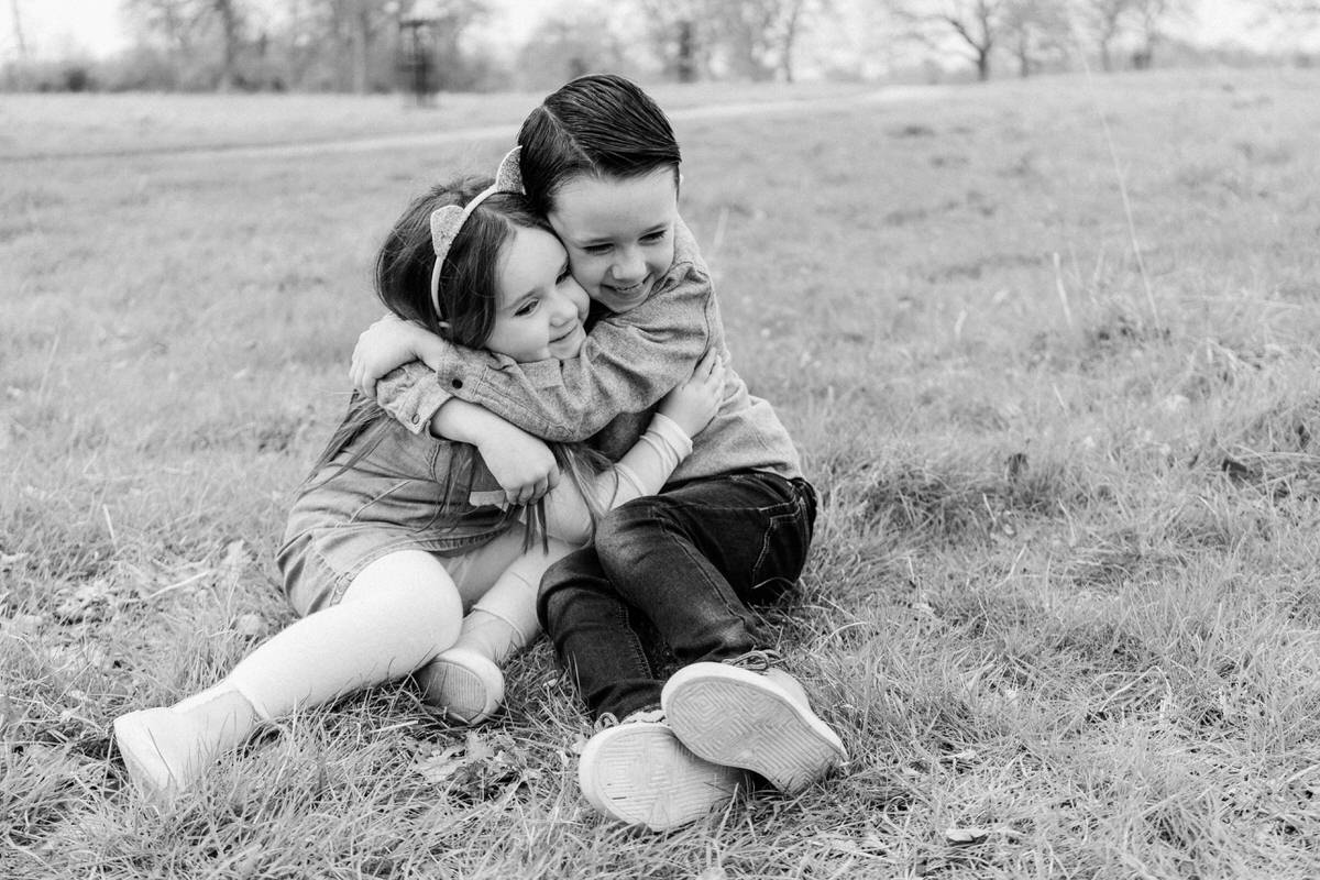 siblings hugging on a family photoshoot in Essex