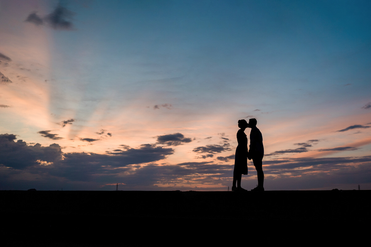 Manningtree engagement shoot, silhouette couple kissing as sunset.