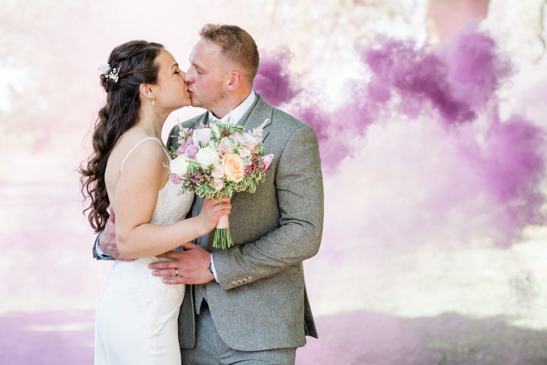 Smoke bomb, bride and groom kissing