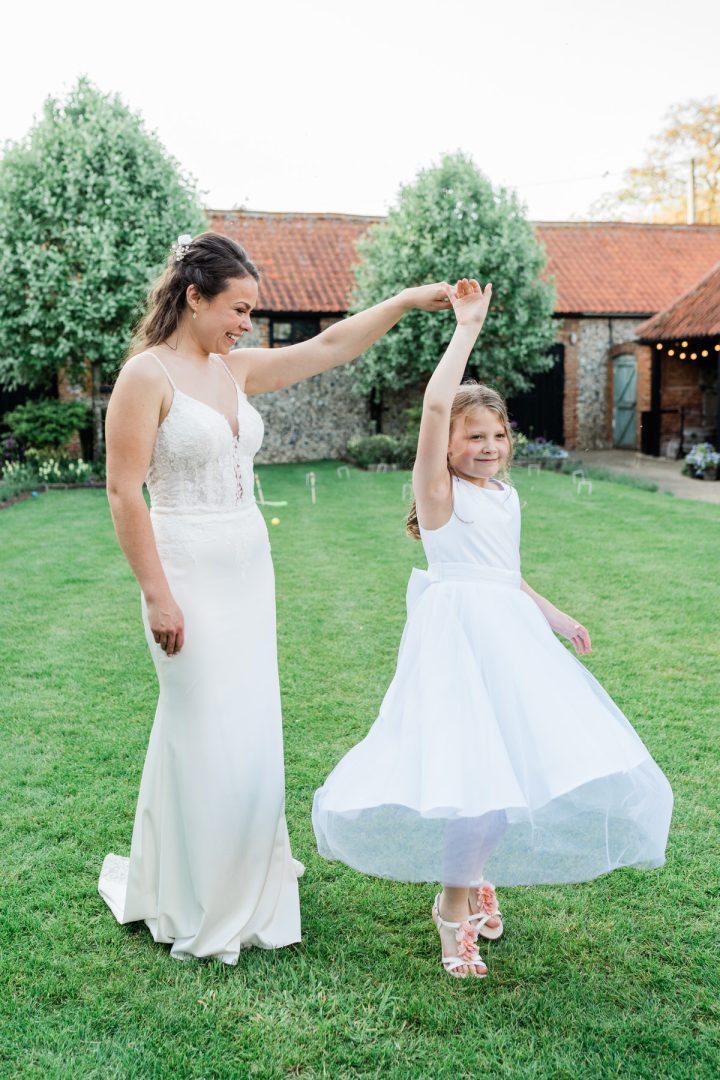 Bride and flower girl in the courtyard at The Granary Estates