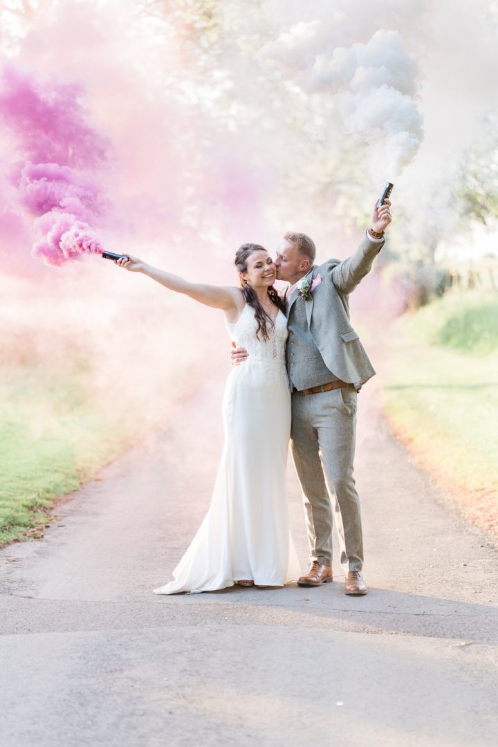 Bride and groom portraits with smoke bombs in Newmarket.
